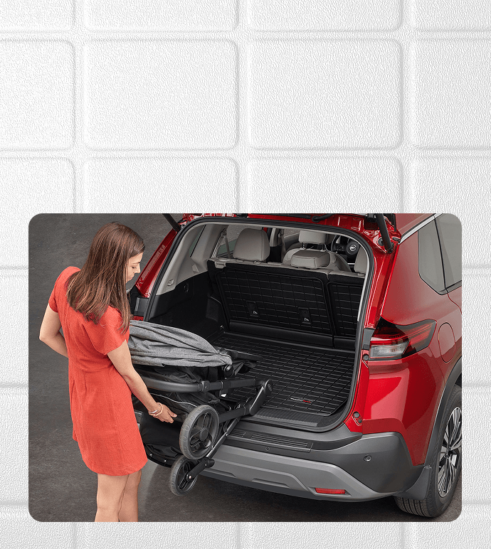 woman placing stroller in trunk with cargo liner installed