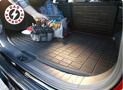 trunk of car with a weathertech liner and tool box sitting on top