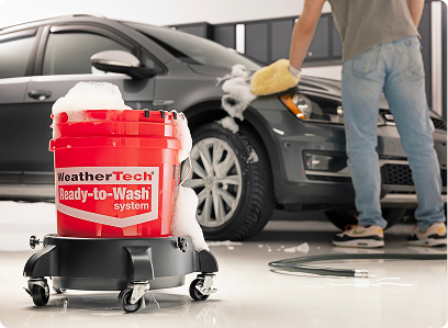 man washing car using