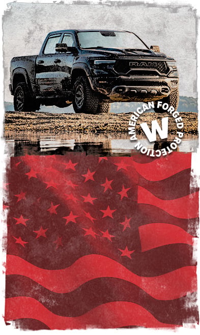 ford f-150 parked next to a mud puddle next to an American flag.