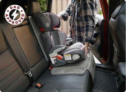 Man installing car seat on top of weathertech car seat protector in car backseat