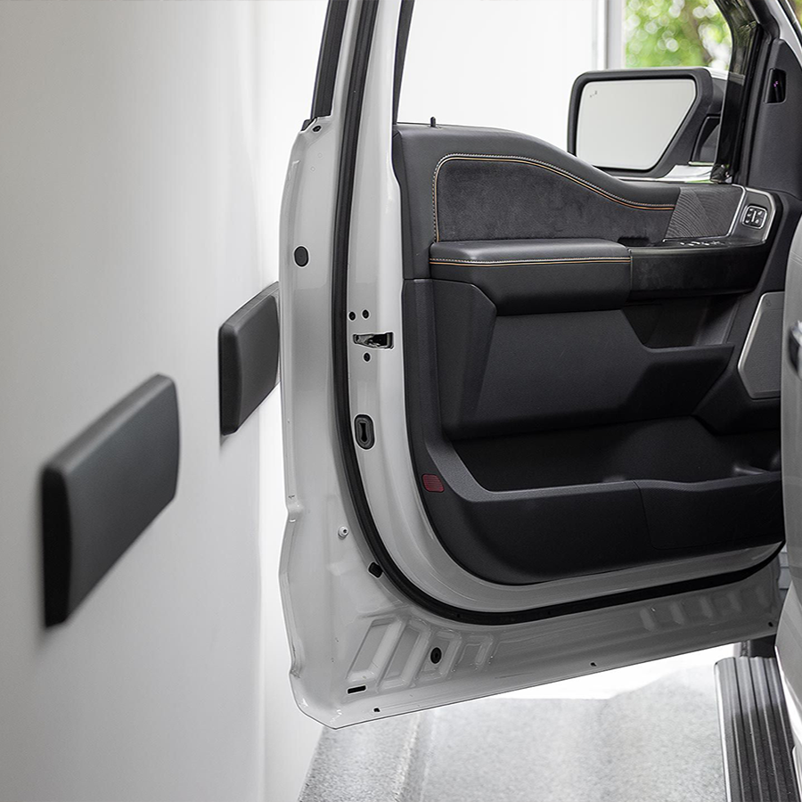 Two weathertech garage wall protectors on garage wall with driver side door opened against it