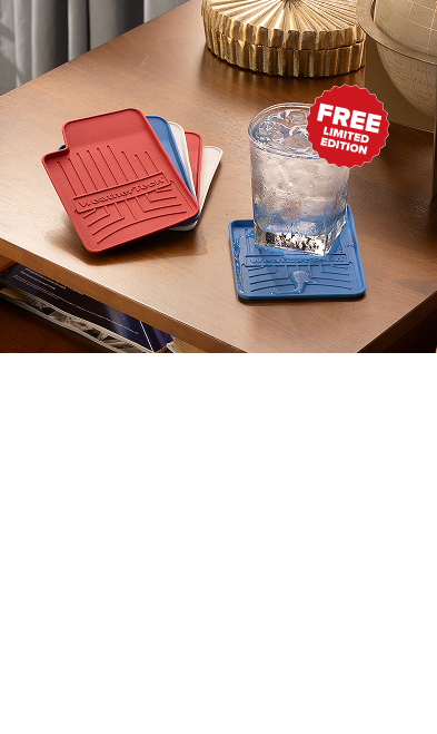 WeatherTech red, white and blue Floorliner coasters on a table with a drink on them.