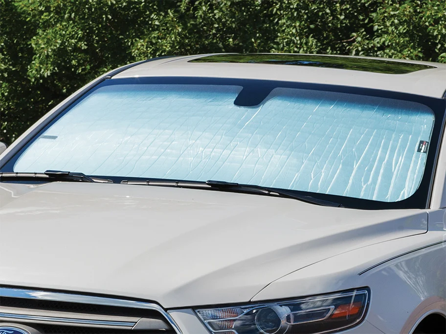 image of sunshade covering the front windshield on a white vehicle
