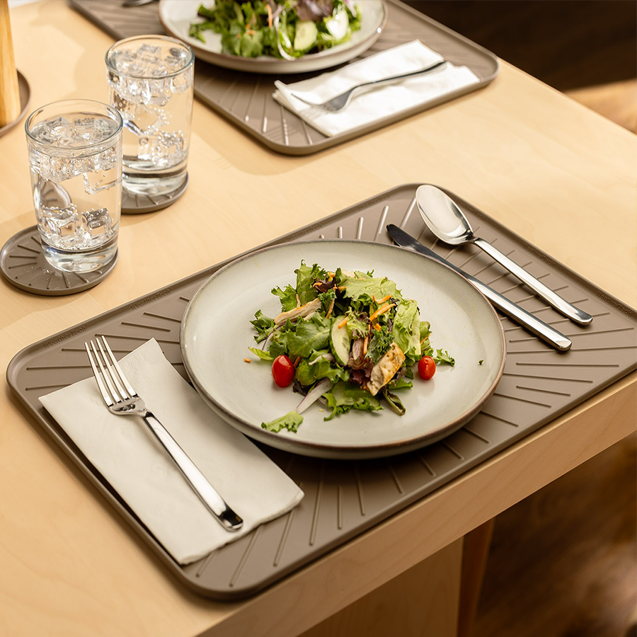 image of weathertech brat mat as a placemat on a table holding silverware and a salad plate