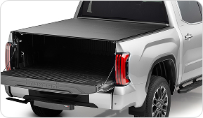 back of silver truck with alloycover installed on top and tailgate open