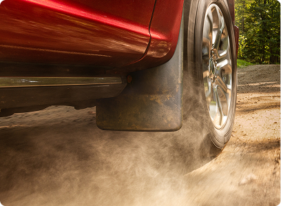 Vehicle driving through dirt with mudflaps installed